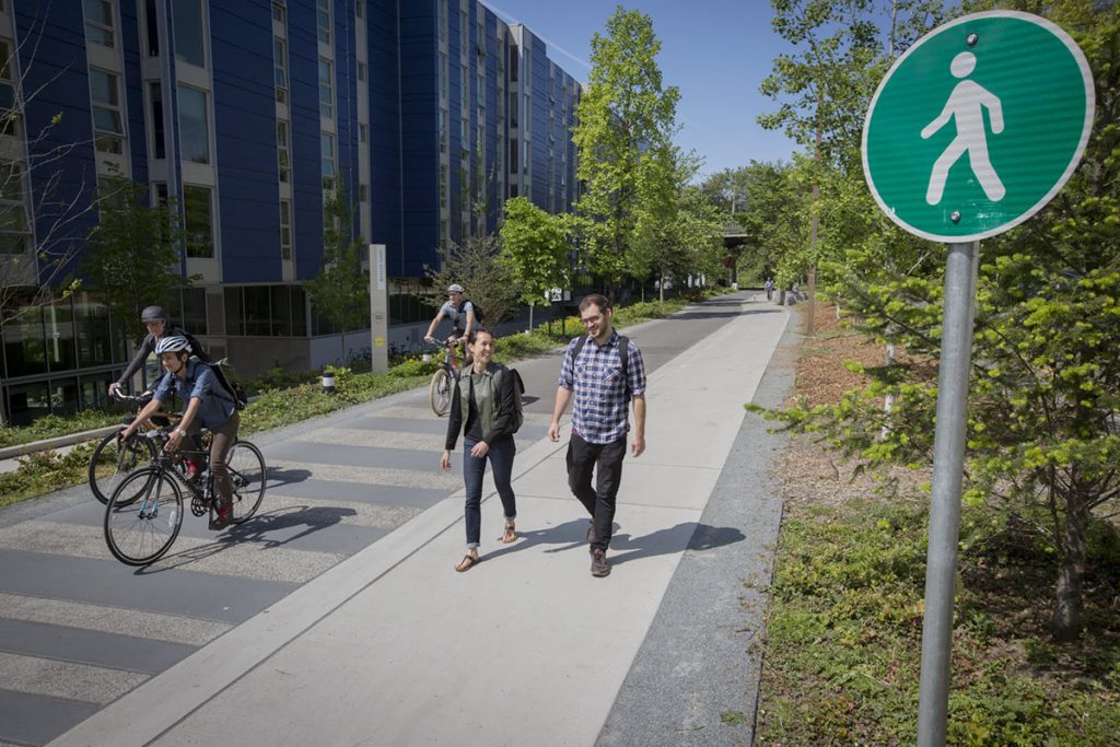 photo of walkers and bicycle riders sharing a path.